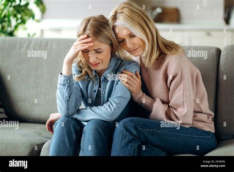 Mother And Daughter Together At Living Room Loving Mature Mom Sits On