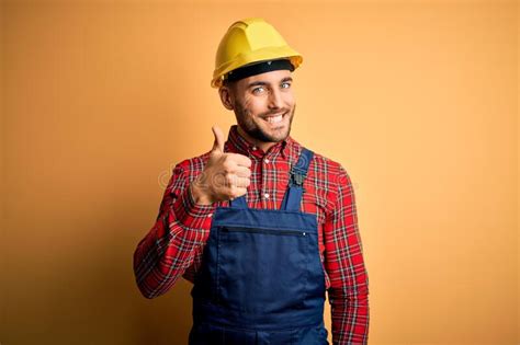 Young Builder Man Wearing Construction Uniform And Safety Helmet Over