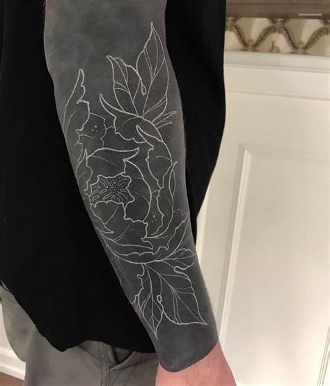 Negative Space Blackwork Tattoo Of A Flower Inked On The Right Forearm