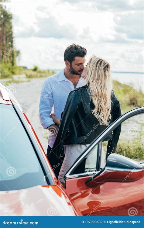 Woman And Handsome Man Kissing And Hugging Near Car Stock Image Image Of Blonde Goodlooking