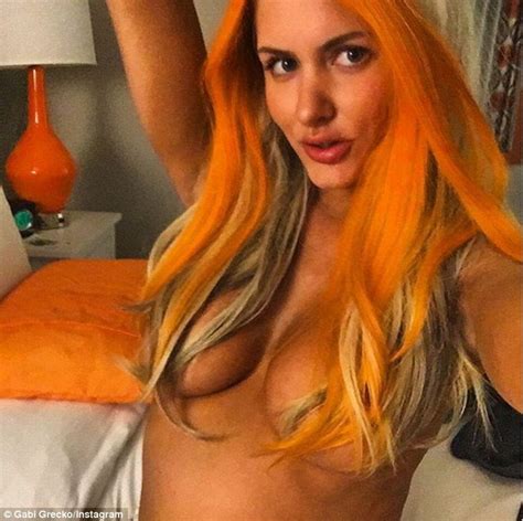 Topless Gabi Grecko Shields Her Modesty With An Orange Wig In Sexy