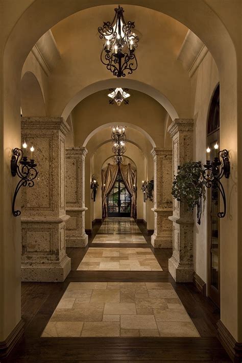 Beautiful Hallway With Archways Lined With Wrought Iron Sconces