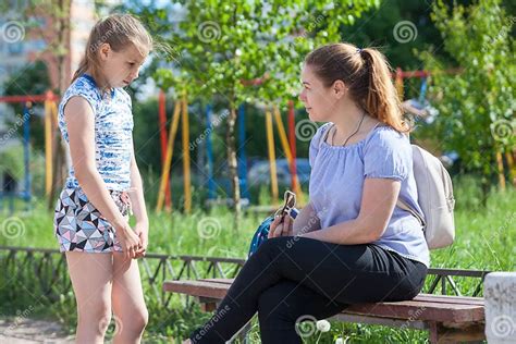 Mother Blows Up Her Young Daughter For Bad Behavior While Walking On Playground Stock Image