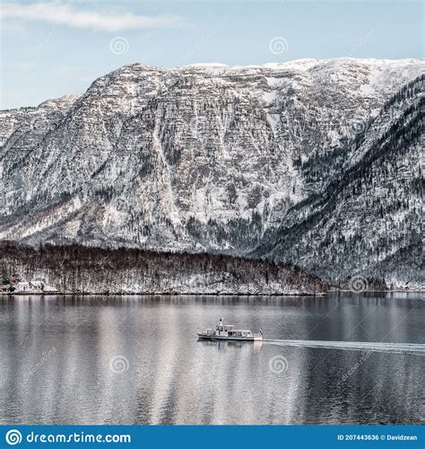 Ferry Boat Stefanie On Hallstattersee Lake Circled By Snow Mountain In