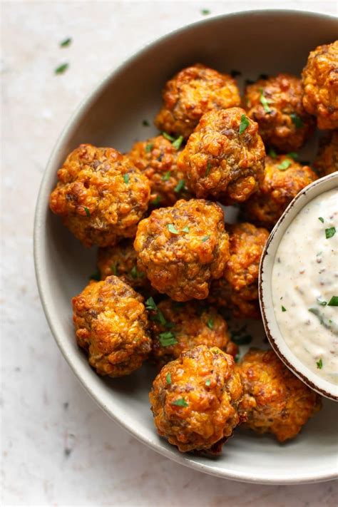 Place colorful goldfish crackers, ritz crackers, and creole seasoning in a resealable bag and crush to tiny pieces. These are the best sausage balls! They're made with pork ...