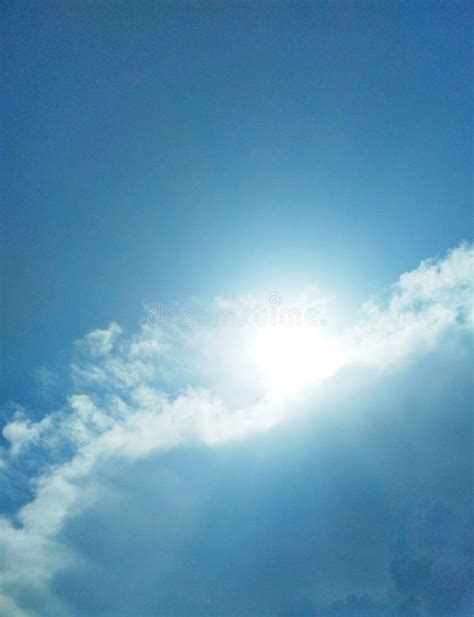 The Sun Brightly Shining In The Cloudy Sky Stock Photo Image Of