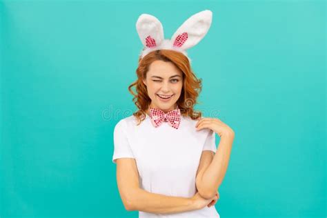 Happy Winking Easter Girl In Bunny Ears And Bow Tie On Blue Background