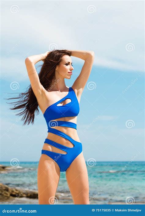Het Jonge En Sexy Vrouw Stellen In Een Blauw Zwempak Op Het Strand