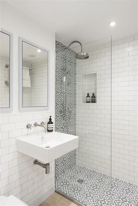 love the use of grey and white patterned tiles in this shower area in this bathroom don t y