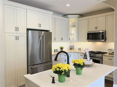 Bright Condo Kitchen With Farm Sink Eggshell Painted Cabinets