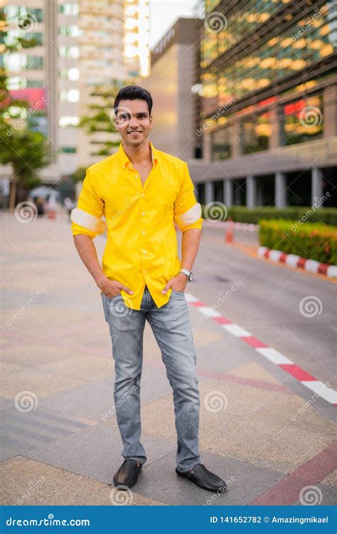 Full Body Shot Of Happy Young Handsome Indian Man Smiling In The City
