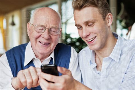 Young Man And Old Man Hanging Out Stock Photo Dissolve