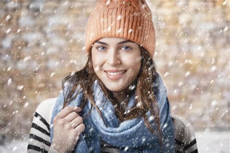 Close Up Portrait Of A Young Woman In Winter Clothes While Falling Snow