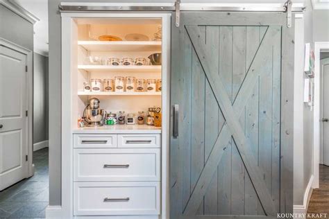 Built In Pantry With White Cabinets Open Shelves And A Sliding Barn