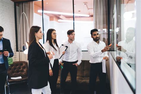 Group Of Diverse Coworkers Talking About Business Strategy Stock Photo