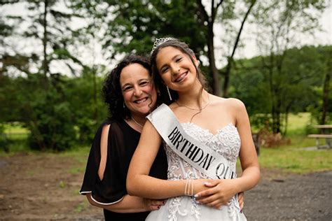 Quinceanera For Hispanic Teenager Posing With Mother Stock Photo