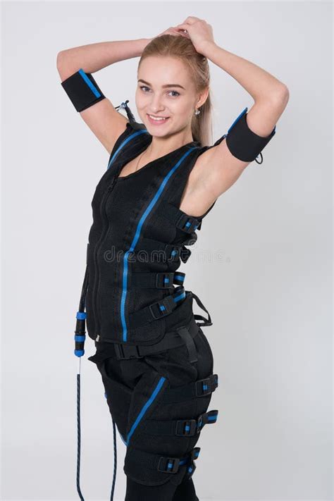 Two Beautiful Woman In Electrical Muscular Stimulation Suit Doing Squat