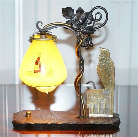Elegant bird lamp that magically balances on any flat surface & provides a swinging glimmer of light with a simple tap. Antiques Atlas - Circa 1930's Bronze Bird Wrought Iron Table Lamp