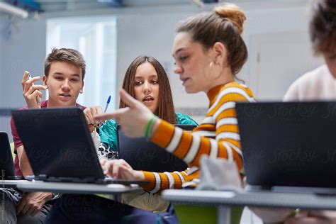 Teenage Students Working Together In The Classroom By Stocksy