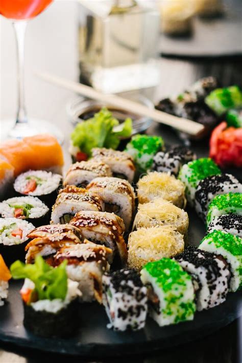 Sushi Roll Set On A Slate Plate And Dark Table In Cafe Stock Image