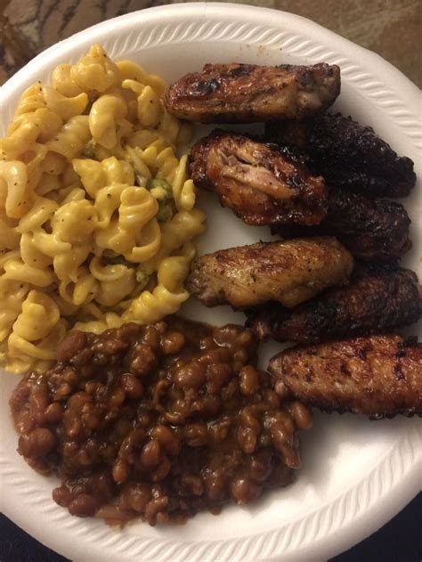 a white plate topped with meat beans and macaroni