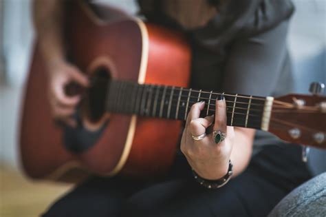 Woman Playing Brown Acoustic Guitar · Free Stock Photo
