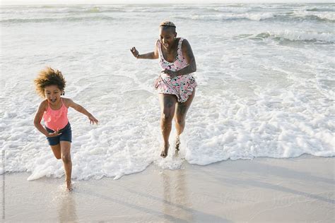 Mother And Daughter Playing At The Beach By Stocksy Contributor