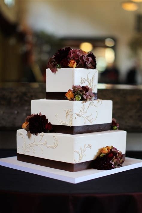 A Chic Square Fall Wedding Cake Decorated With Brown Ribbons And Moody