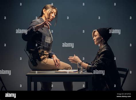 An Experienced Investigator During An Interrogation At A Police Station Shows The Criminal Girl