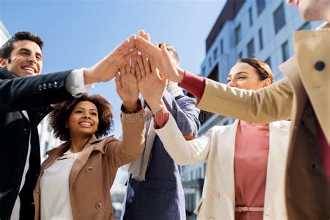 Group Of Happy People Making High Five In City Stock Photo Image Of