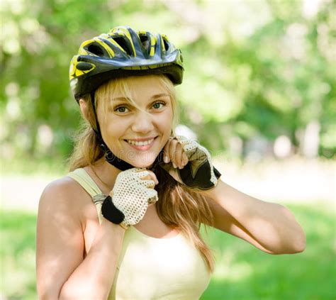Woman Putting Biking Helmet On Outside During Bicycle Ride Stock Photo Image Of Leisure Park