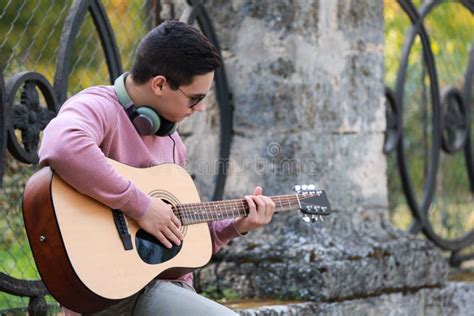Young Man Playing Guitar Outdoors Stock Photo Image Of Performance