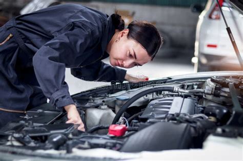 Beautiful Female Auto Mechanic In Uniform Working With Engine Vehicle