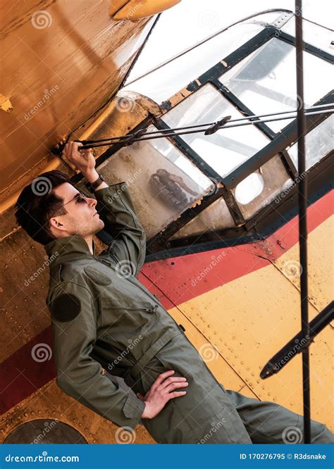 A Handsome Young Pilot Standing On The Wing Of A Plane Stock Image