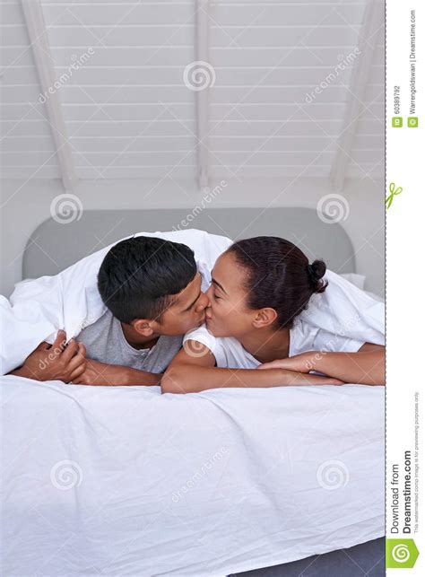 couple kiss bedroom stock photo image  black indoors