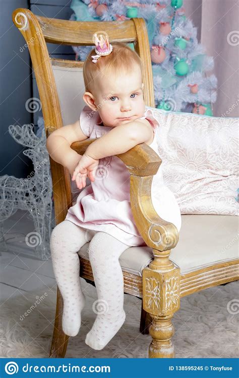 Portrait Of A Cute Little European Blond Princess Girl With A Crown In