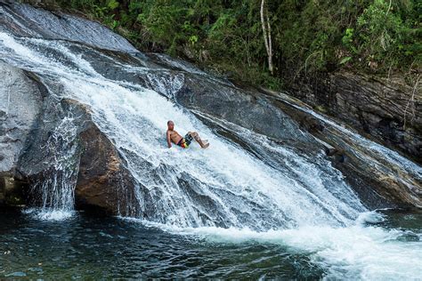 Man Sliding Down Waterfall In Atlantic Photograph By Vitor Marigo