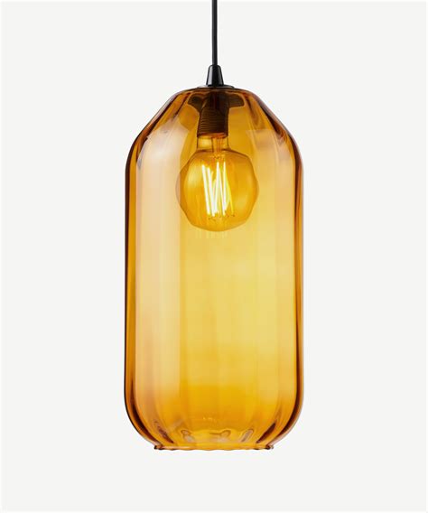 A Yellow Glass Light Hanging From A Black Cord