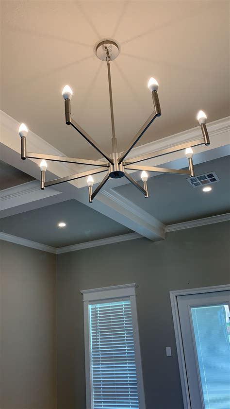 A modern light fixture in the living room of this new build with smart