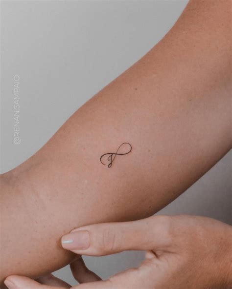 Infinity Symbol And Letter J Tattoo On The Inner Arm