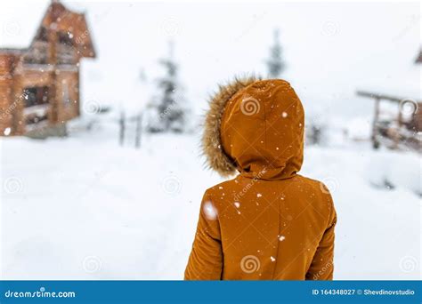 girl backs in winter snow street walk outdoor countryside walk alone travel cold weather