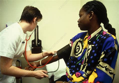 Nurse Taking Blood Pressure Of A Female Patient Stock Image M532