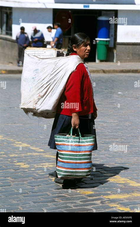 Peruvian Lady Carrying Bag Over Her Shoulder Crossing A Road Cusco