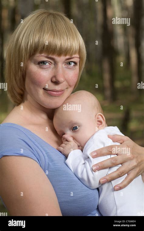 A Mother Holding Her Baby Outdoors Stock Photo Alamy