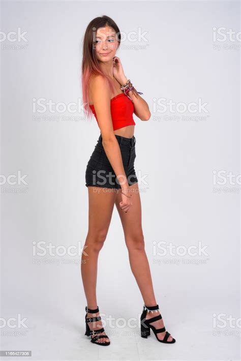 Full Body Shot Of Young Beautiful Rebellious Woman Standing Stock Photo