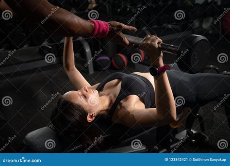 Personal Trainer Helping Woman Bench Press In Gym Training With Barbell Stock Image Image Of
