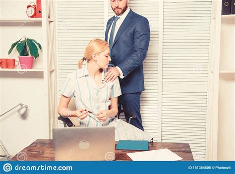 Boss Sexual Harassing To Blonde Secretary At Workplace Stock Photo