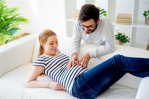 Husband Touching His Pregnant Wifes Belly Stock Photo Image Of