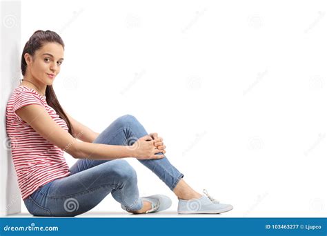 Teenage Girl Sitting On The Floor And Leaning Against A Wall Stock