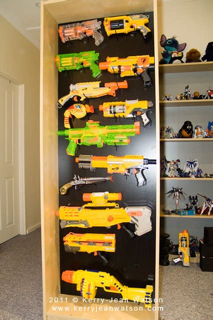 If on a wall, get peg board, and the different shaped metal pegs that you can stick into the peg board, and arrange them to i run a nerf club at my university, and we want a weapons rack to put up on the wall of our clubroom. Nerf Gun Rack | Flickr - Photo Sharing!